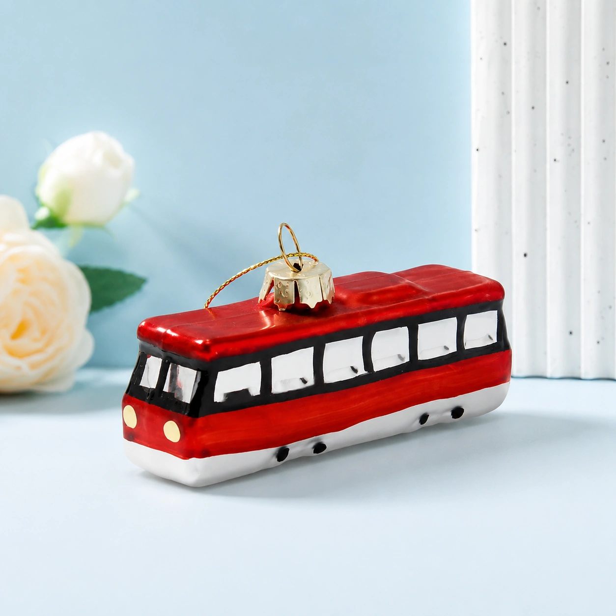 Hand-painted glass Christmas ornament shaped like London double decker bus