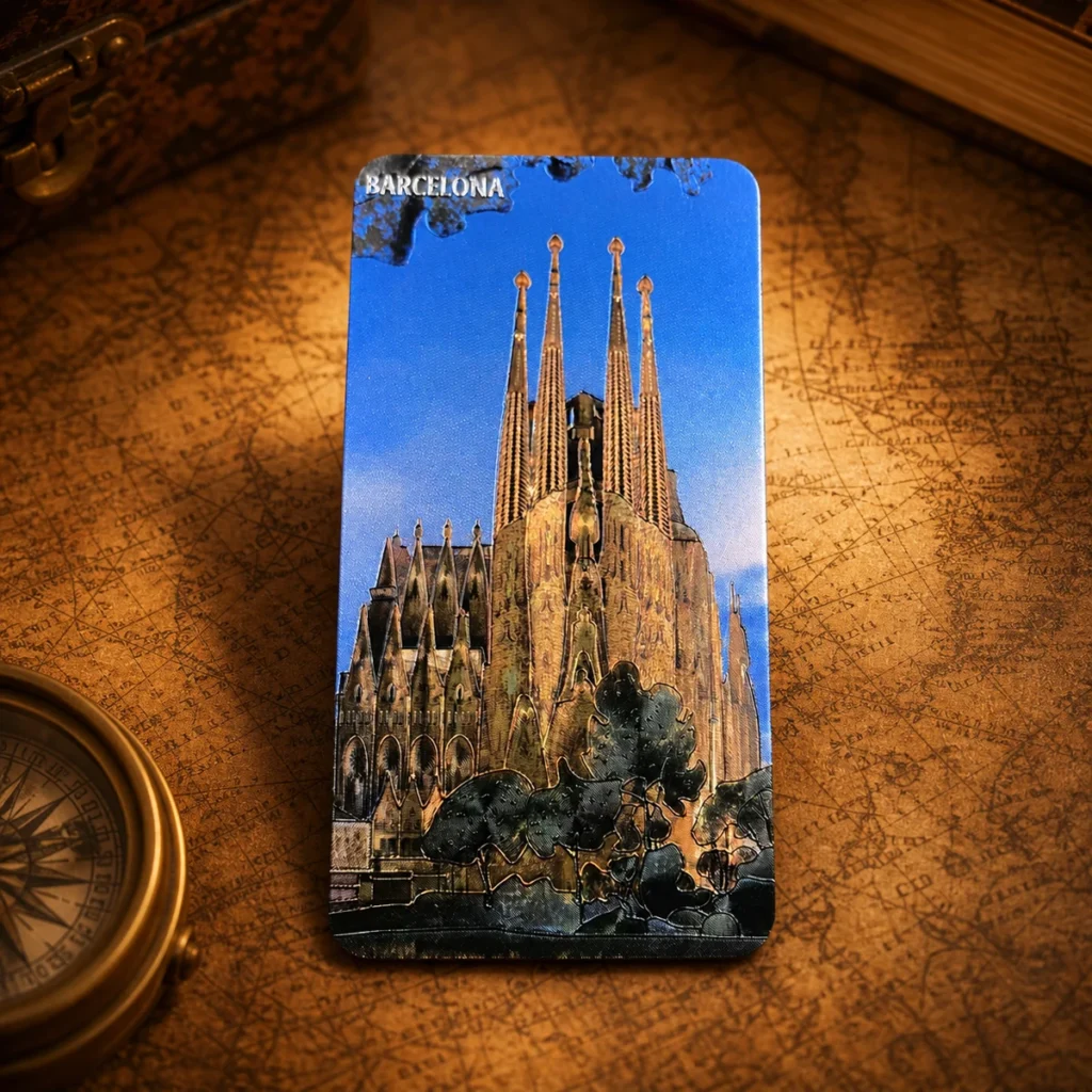 Custom aluminum foil Barcelona souvenir fridge magnet on a dark travel map