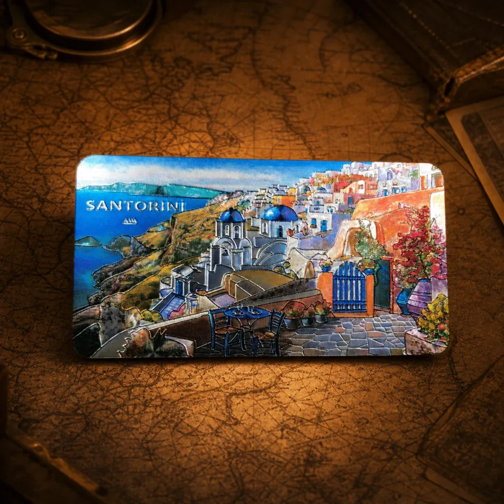 Custom aluminum foil Santorini souvenir fridge magnet on a dark travel map