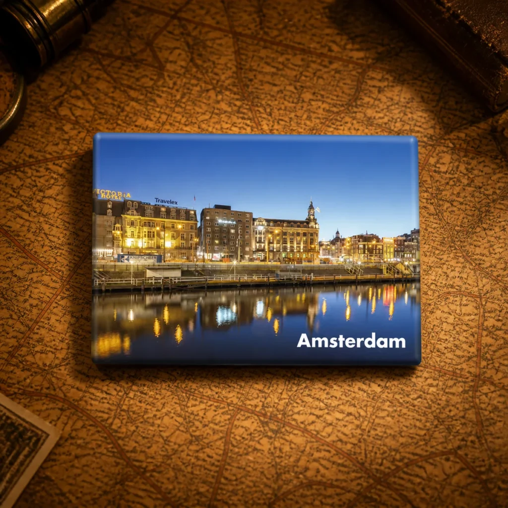 Custom tinplate Amsterdam souvenir fridge magnet on a dark travel map
