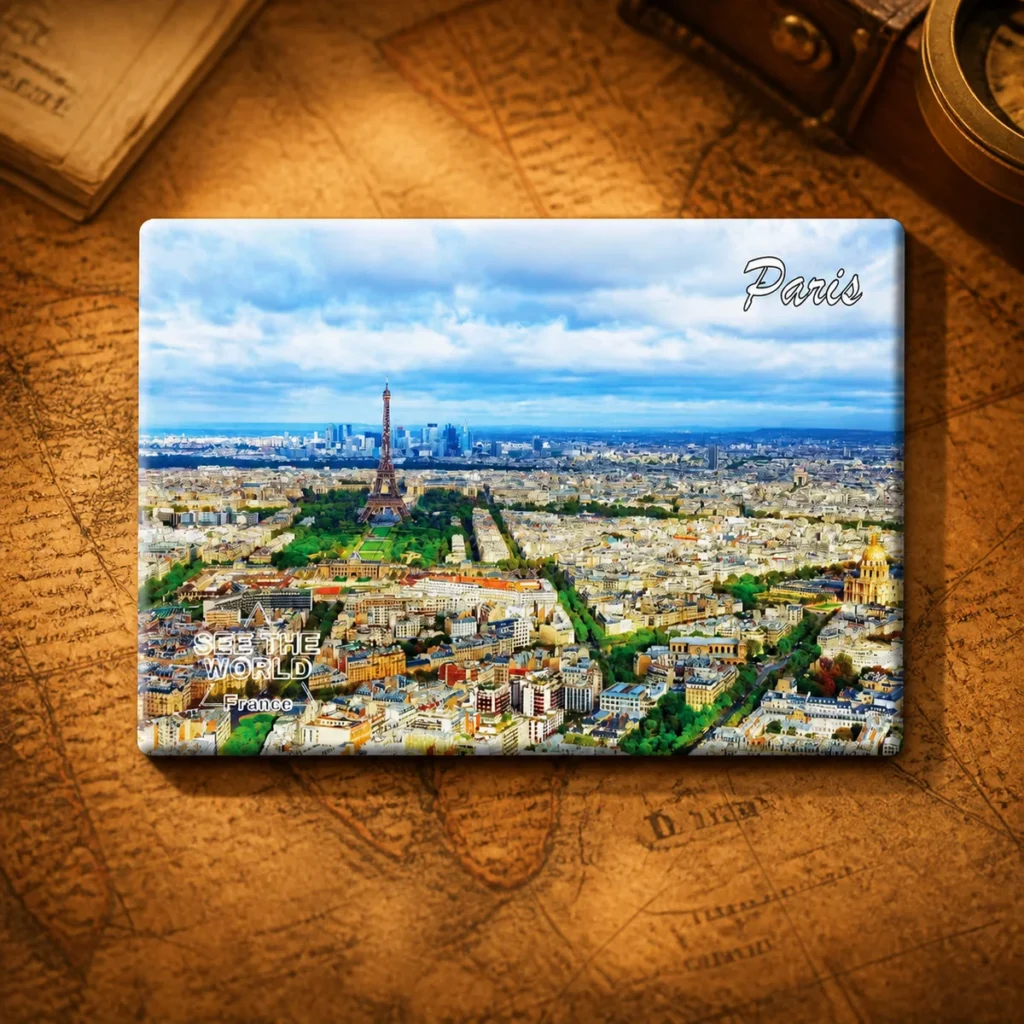 Custom tinplate Paris souvenir fridge magnet on a dark travel map